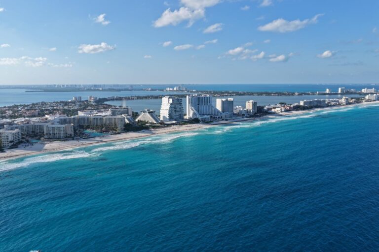 Banderas de seguridad y torres de guardavidas en playas públicas de Cancún certificadas con Blue Flag para la temporada de Semana Santa 2026.